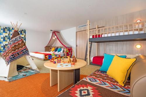 a childrens room with a bunk bed and a table at Kirishima Kokusai Hotel in Kirishima