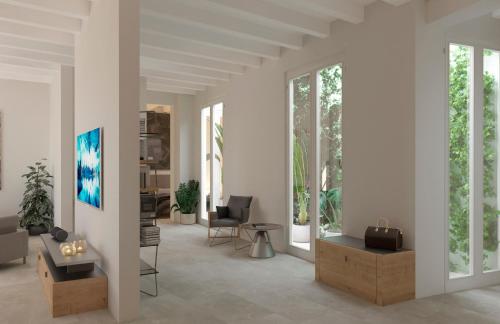 a living room with white walls and windows at Aparttime Palma mit 3 MeerBlick Dach-Terrassen in Palma de Mallorca