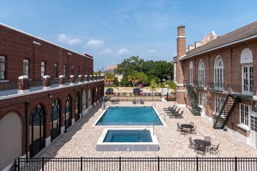 a swimming pool in a courtyard between two buildings at Holy Angels Bywater Hotel and Residences in New Orleans