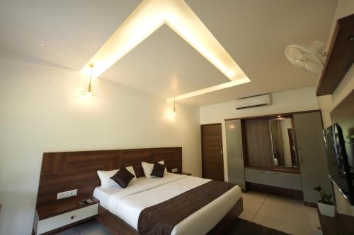 a bedroom with a large bed with a sloped ceiling at jungle view resort in Mananthavady