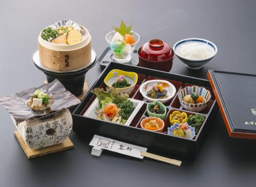 a table topped with a tray of food and rice at Ryokan Asunaro in Takayama