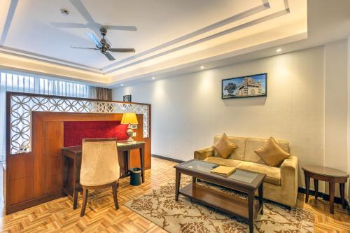 a living room with a couch and a table at LP Vilas in Dehradun