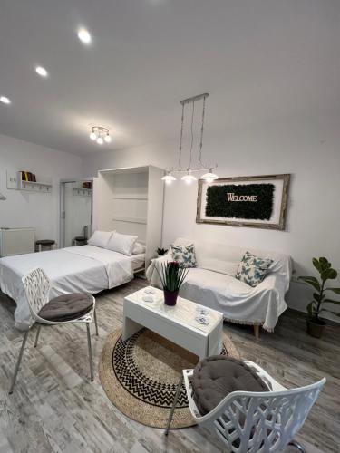 a living room with two beds and a couch at Selenity studio(close to two metro stations) in Piraeus