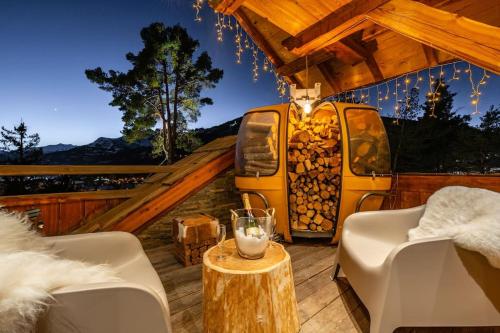 a yellow bus parked on a deck in a house at CHALET LUXE DE LA CROIX DU FRENE in Briançon