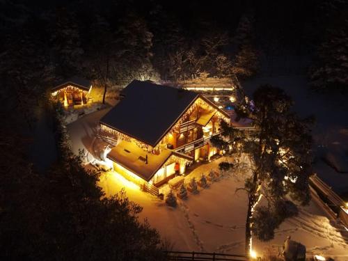 an overhead view of a house in the snow at night at CHALET LUXE DE LA CROIX DU FRENE in Briançon