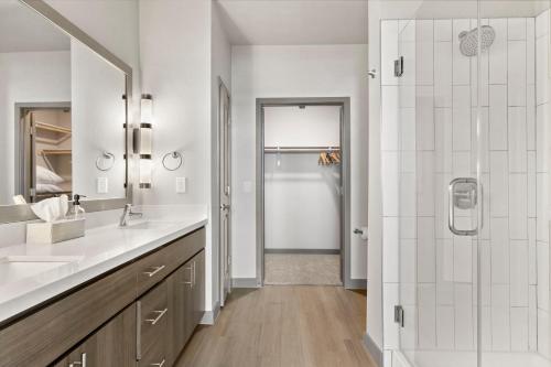 a white bathroom with a sink and a shower at Cozysuites PHX RORO Gym, Pool, Pets, Parking! #14 in Phoenix