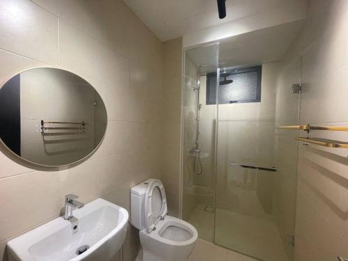 ein Badezimmer mit einem WC, einem Waschbecken und einem Spiegel in der Unterkunft The Apple Residence 3BR with 10 Pax - 1KM to Jonker in Malakka