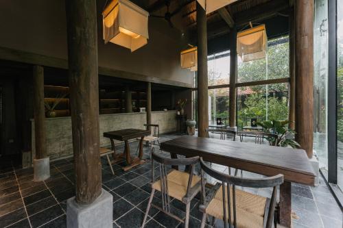 a dining room with a wooden table and chairs at TOKI Retreat Vân Long in Ninh Binh
