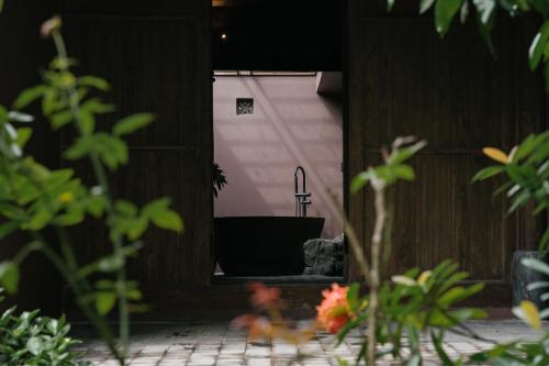 a view of a bathroom with a tub in a building at TOKI Retreat Vân Long in Ninh Binh
