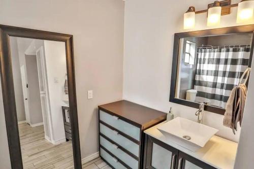 a bathroom with a sink and a mirror at San Antonio Escape in San Antonio