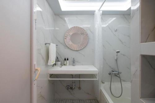 a white bathroom with a sink and a mirror at Reimi Mondo301 in Tokyo