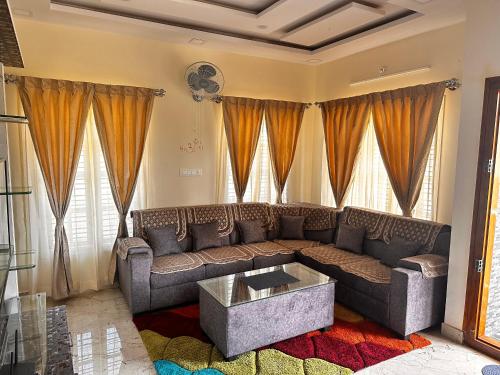 a living room with a couch and a table at DEEYA Guest House - A Luxury Home Stay in Mysore