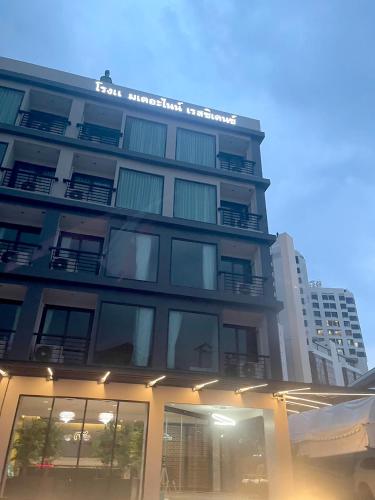 a tall building with a sign on top of it at The 9 Residence Hotel in Bangkok