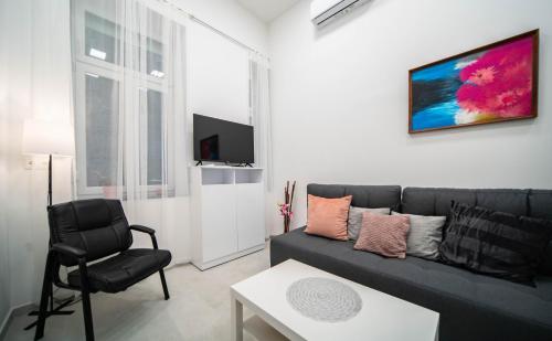 a living room with a couch and a chair at Free parking Basilica Rob's Home - AC, Wi-Fi, smart TV in Budapest