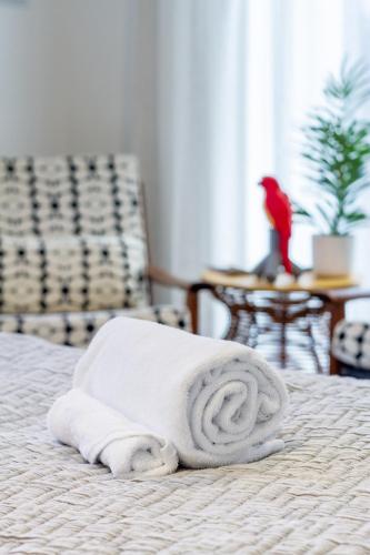 a stack of towels sitting on a bed at Okioki - Seaside Escape in Christchurch
