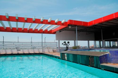 a swimming pool on the roof of a building at Hotel Presidency in Cochin