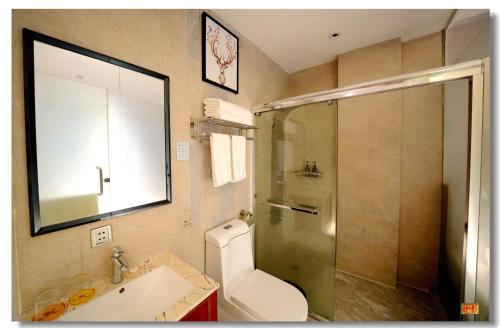 a bathroom with a shower and a toilet and a sink at pristine in Manila