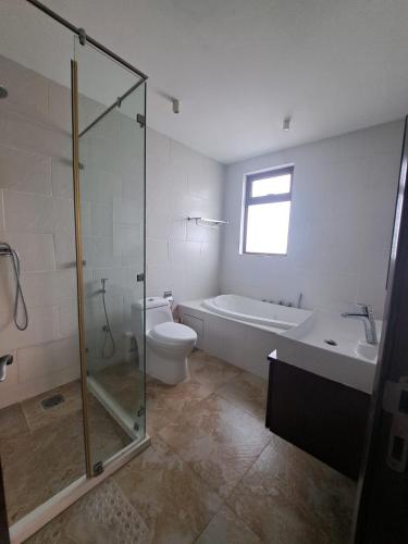 a bathroom with a shower and a toilet and a sink at Marique villa in Mombasa