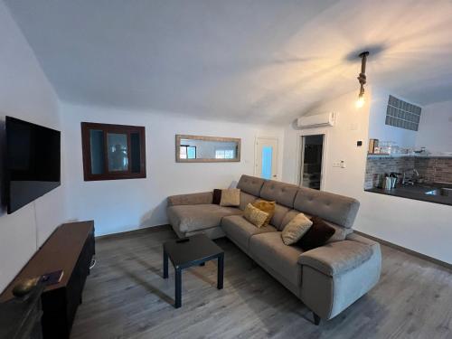 a living room with a couch and a table at Morgan apartamentos Marbella centro in Marbella