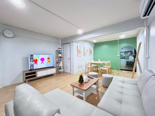 a living room with a white couch and a table at HDY 66 home in Hat Yai