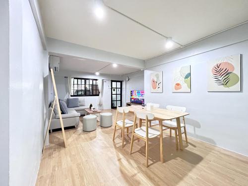 a living room with a table and a couch at HDY 66 home in Hat Yai