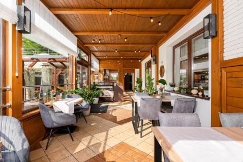 an outdoor dining area with tables and chairs at Hotel Łaziska in Czchów