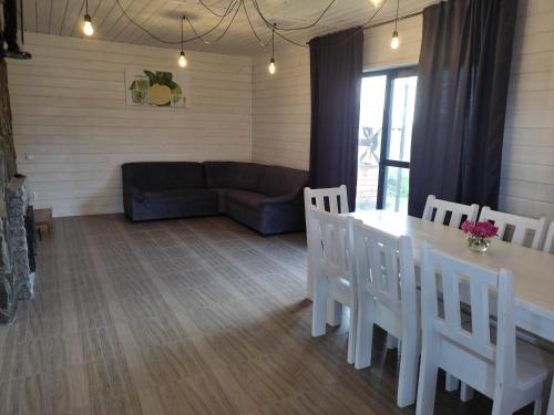 a living room with a table and chairs and a couch at Сімейний куточок in Svityazʼ