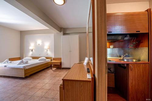 a bedroom with a bed and a sink in a room at Castella Beach in Alissos