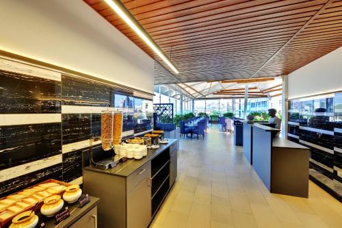 a restaurant with a buffet line in a cafeteria at Iris The Business Hotel in Bengaluru