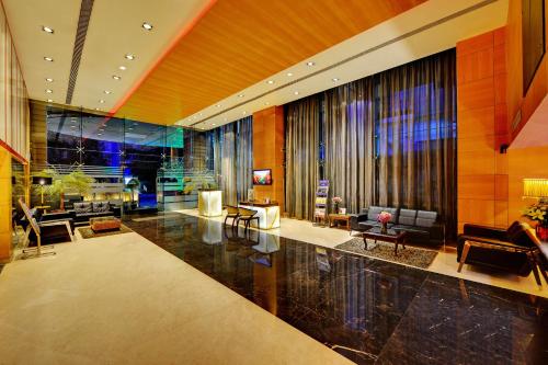 a living room with a couch and a table at Iris The Business Hotel in Bengaluru