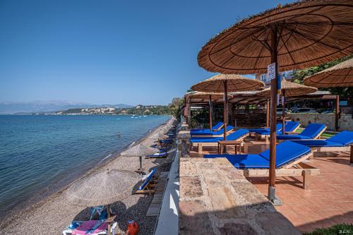 a group of chairs and umbrellas on a beach at Castella Beach in Alissos