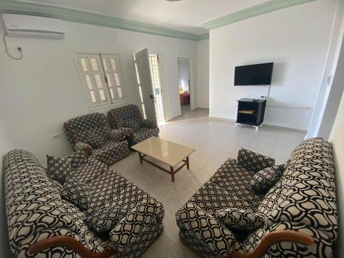 a living room with couches and a table at ltifi villas aghir in Midoun