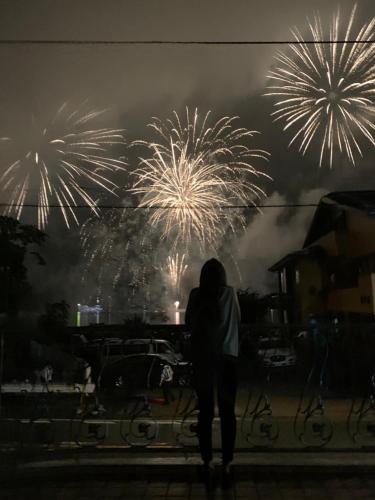 a person walking in front of a fireworks display at HAKONE DOMA in Hakone