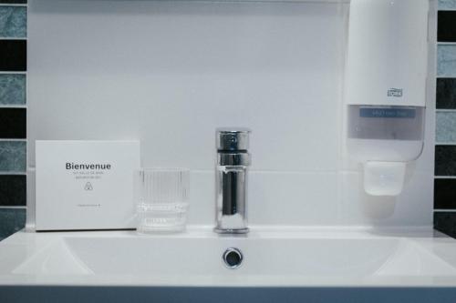 a sink with a faucet and a glass on it at F2 "Paris Jaude " Clermont Fd in Clermont-Ferrand