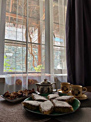 a table with a plate of bread and cups of coffee at Home-restaurant in Vanadzor in Vanadzor