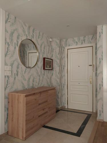 a bathroom with a wooden dresser and a mirror at Granada Centro Congresos in Granada