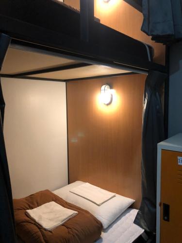 a room with a bunk bed with two towels at Thyme Xeriscape Hostel in Kanchanaburi