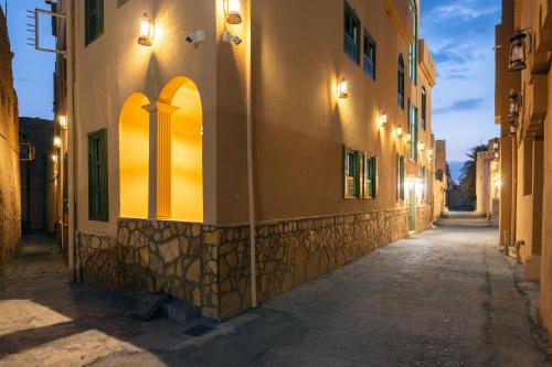an alley in an old town at night at House 76 in Nizwa