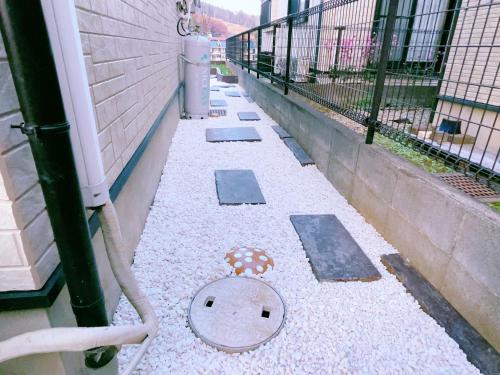 an empty alley with a drain in a building at Miyama House in Hachioji