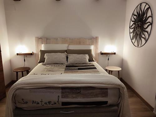 a bedroom with a large bed with two tables at Casa Min in Lasieso