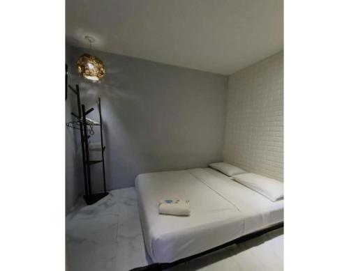 a small room with a white bed with a pillow on it at EXPRESS OYO HOTEL in Kuala Lumpur