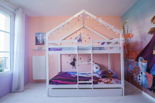 - une chambre avec des lits superposés blancs dans l'établissement Air-conditioned apartment, walking distance to disney - DISNEY MAGICAL HOMES, PARIS, à Serris