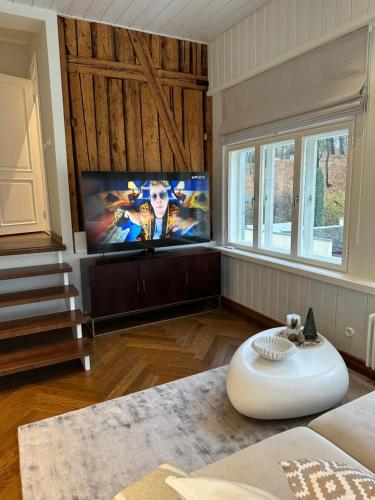 a living room with a couch and a tv at Luxurious Vallikraavi apartment with Sauna, free parking in Tartu