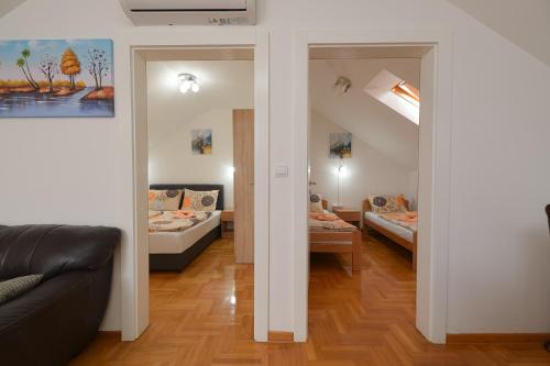 a living room with two beds and a couch at Capitol Apartmani in Vrnjačka Banja