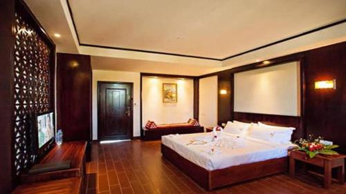 a bedroom with a large bed and a couch at Apartemen suhat in Malang