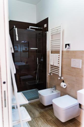 a bathroom with a sink and a toilet and a shower at Residence Le Vie del Centro in Matera