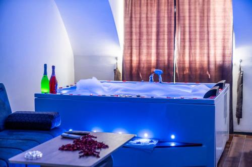 a blue tub with a table in a room at AYYA SUİT HOTEL in Eskihisar