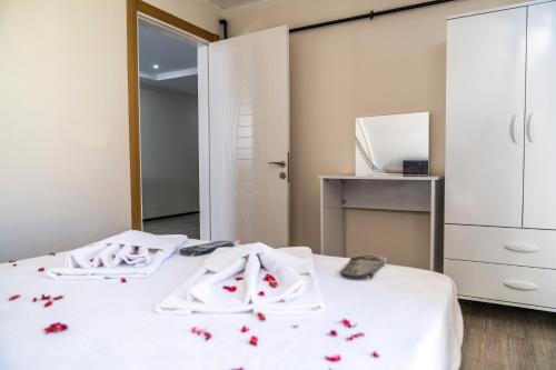 a bedroom with two beds with red flowers on them at AYYA SUİT HOTEL in Eskihisar