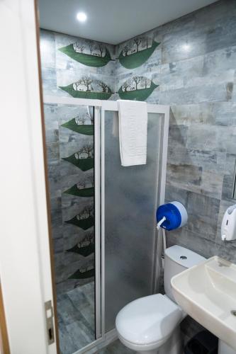 a bathroom with a shower with a toilet and a sink at AYYA SUİT HOTEL in Eskihisar