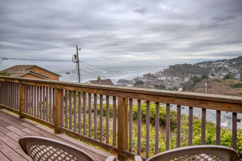 a balcony with two chairs on a wooden deck at Lincoln City Beach House in Lincoln City